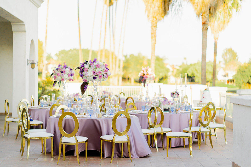  one bride in a black women’s tuxedo with a black diamond shaped bow tie and one bride in a white mermaid style gown with a beaded bodice and strapless neckline 