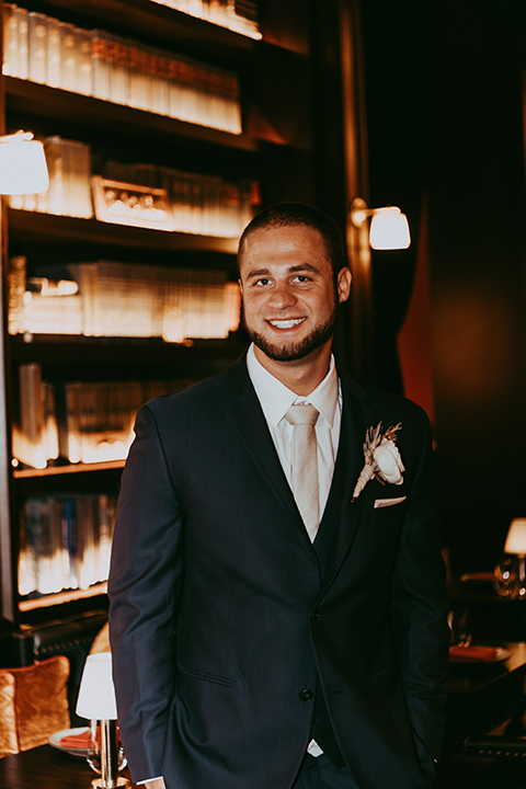  groom in a navy suit and bow tie 