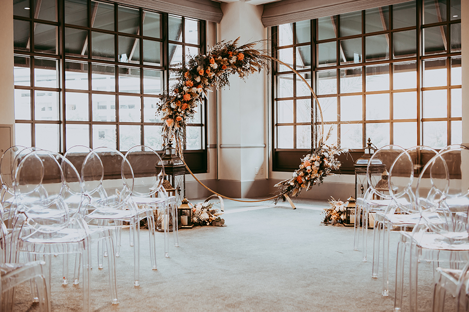  ceremony space with neutral florals and circular arch 