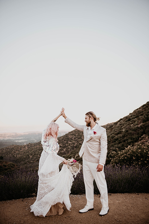  the bride in a fun sequin gown with a faux fur coat and the groom in an ivory paisley tuxedo