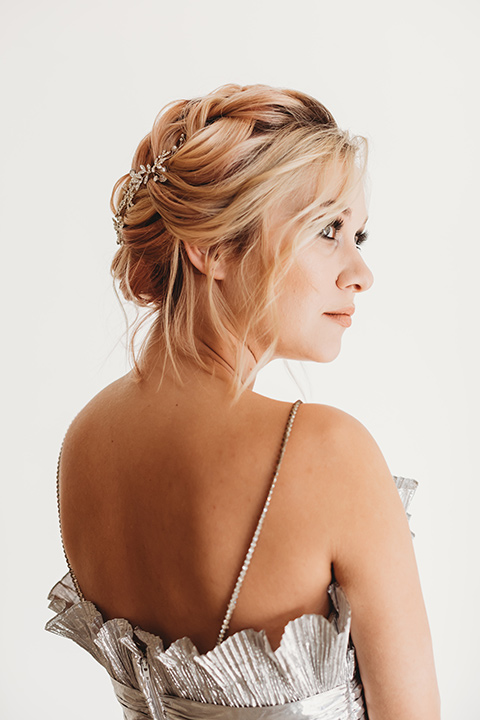  bride in a silver gown with her hair in a braided bun