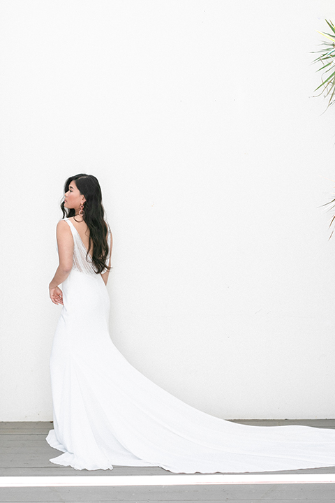  bride in a formfitting gown with a high neck and a long train