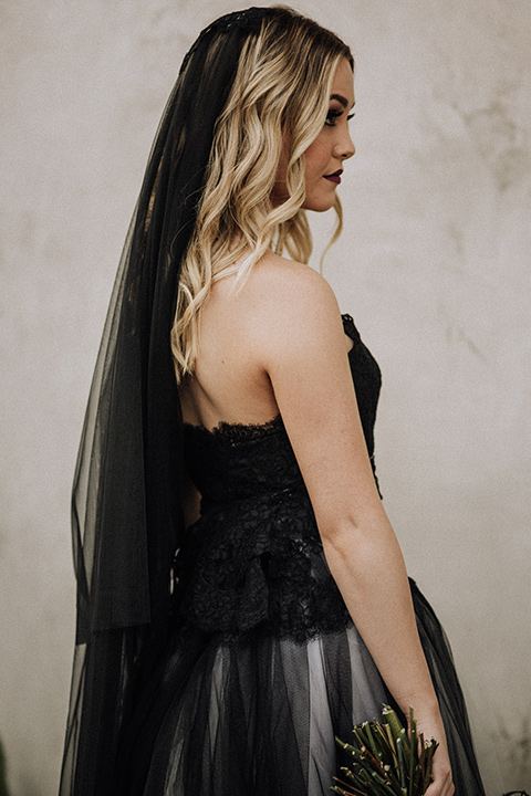  bride in a black and grey gown with a black tulle veil 