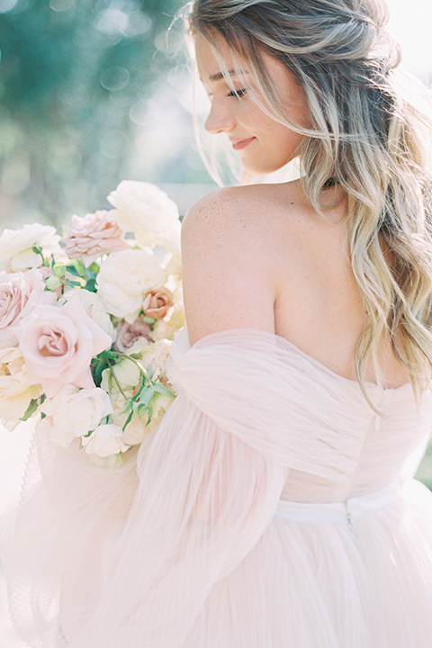  bride in a blush gown with off the shoulder sleeves 