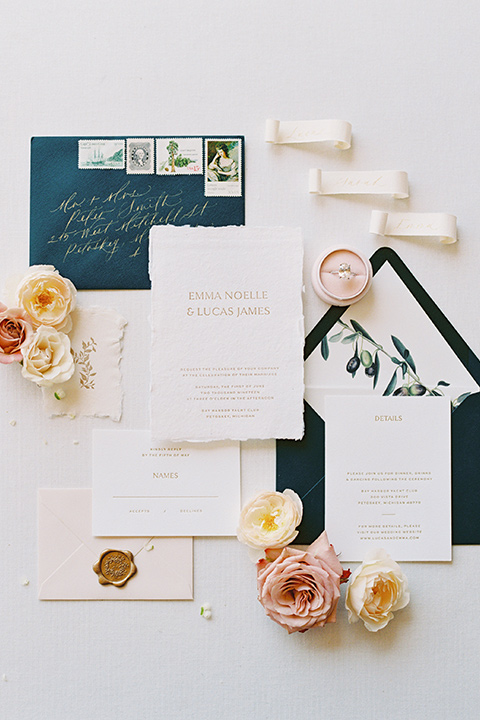  bride in a blush gown with off the shoulder sleeves and the groom in a black notch lapel tuxedo and black bow tie 