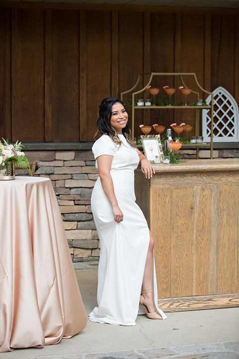  bride in a modern formfitting gown with cap sleeves and a high neck 