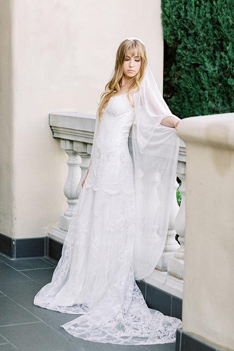  groom in a café brown suit and a gold velvet bow tie bride in a white silk gown with a cape overlay