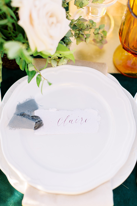  groom in a café brown suit and a gold velvet bow tie bride in a white silk gown with a cape overlay