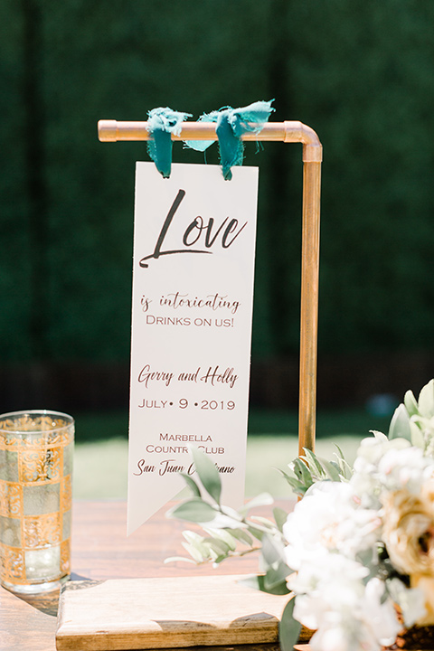  groom in a café brown suit and a gold velvet bow tie bride in a white silk gown with a cape overlay 