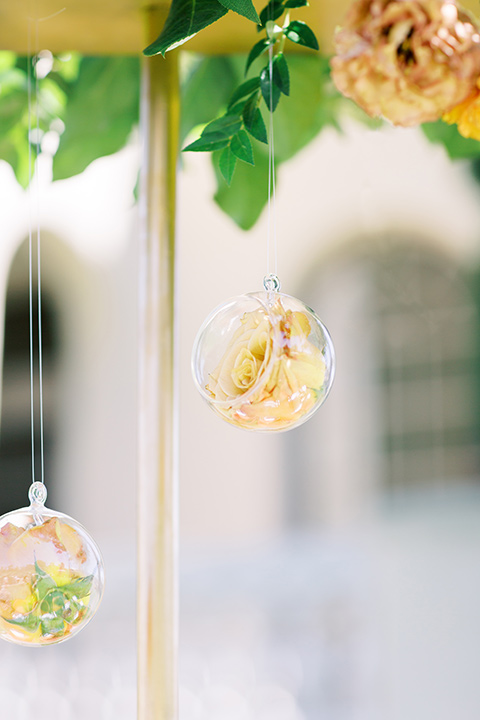  groom in a café brown suit and a gold velvet bow tie bride in a white silk gown with a cape overlay