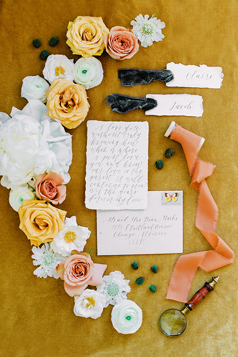  groom in a café brown suit and a gold velvet bow tie bride in a white silk gown with a cape overlay