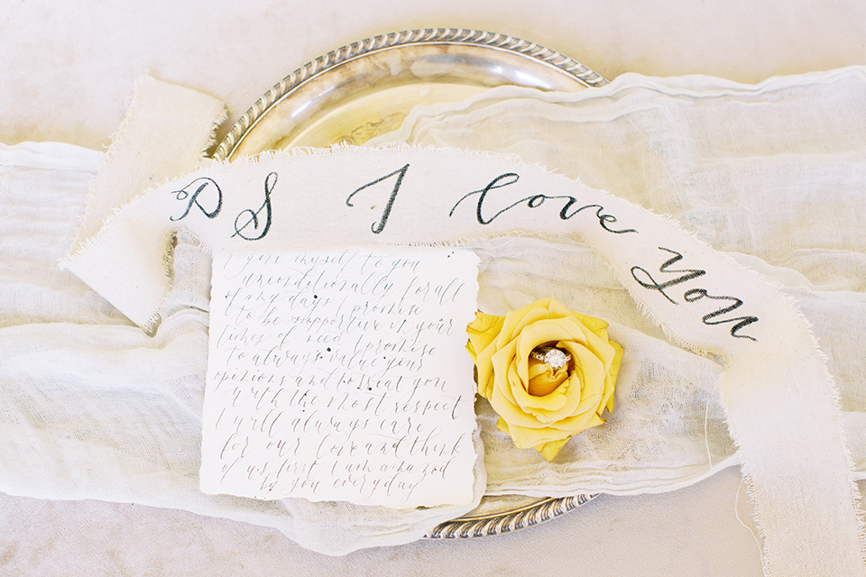  groom in a café brown suit and a gold velvet bow tie bride in a white silk gown with a cape overlay 