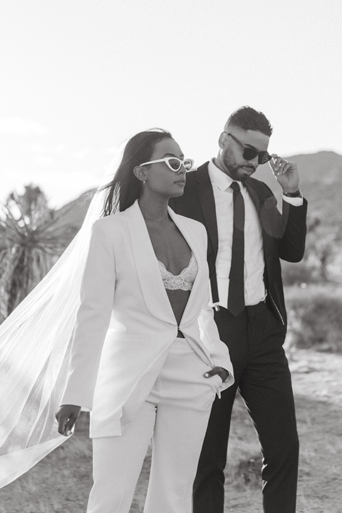  palm spring elopement with a chic black tie vibe the groom in a black tuxedo and the bride in a short tuxedo coat dress