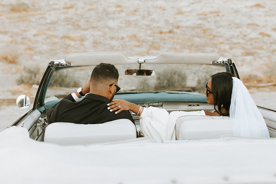  palm spring elopement with a chic black tie vibe the groom in a black tuxedo and the bride in a short tuxedo coat dress 