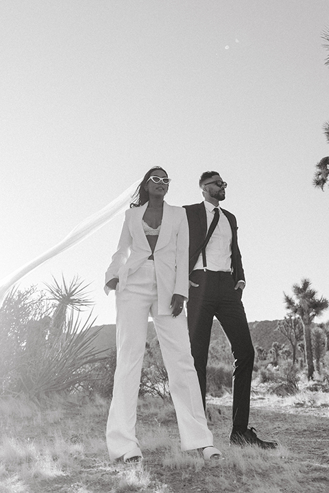  palm spring elopement with a chic black tie vibe the groom in a black tuxedo and the bride in a short tuxedo coat dress 