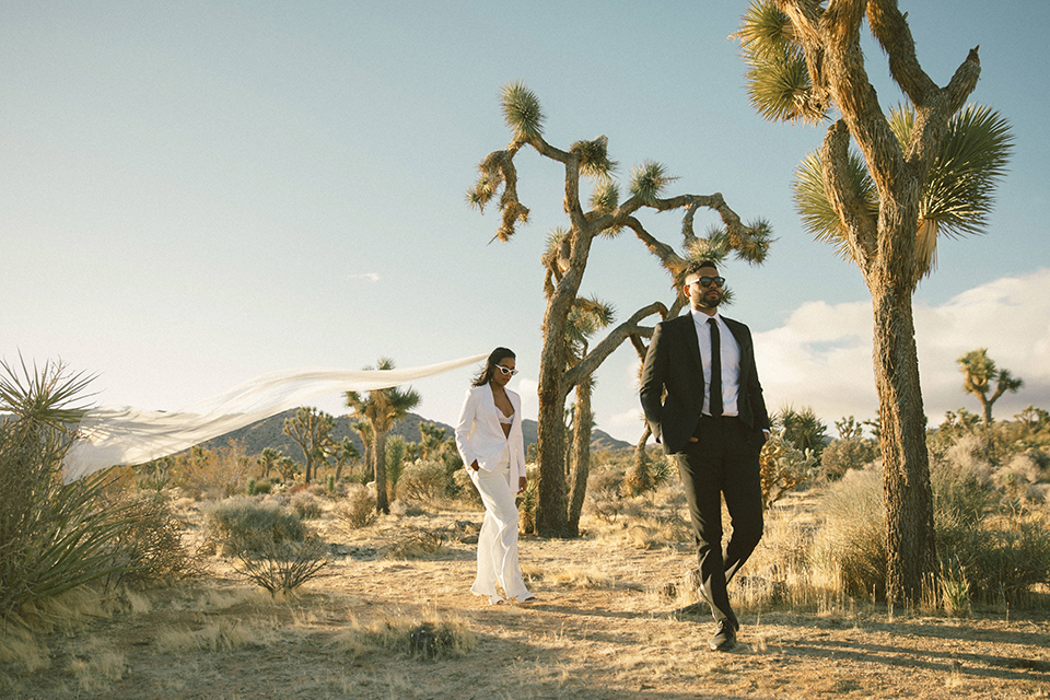  palm spring elopement with a chic black tie vibe the groom in a black tuxedo and the bride in a short tuxedo coat dress 