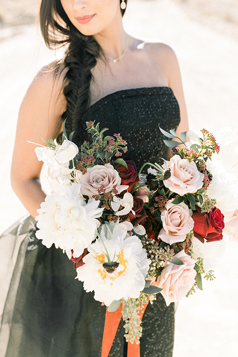  bride in a black jumpsuit with a tulle overlay