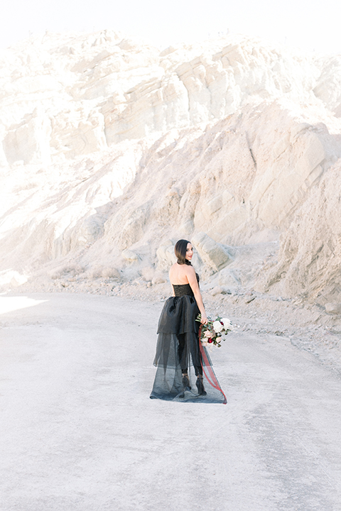  bride in a black jumpsuit with a tulle overlay