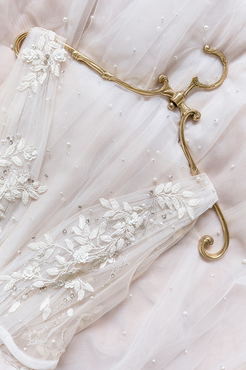  close up of a bridal gown with an illusion neckline 