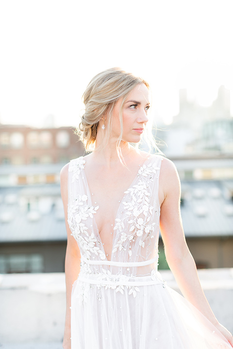  the bride in a white gown with an illusion neckline and hair in a low bun, the groom in a caramel brown suit with a chocolate brown bow tie