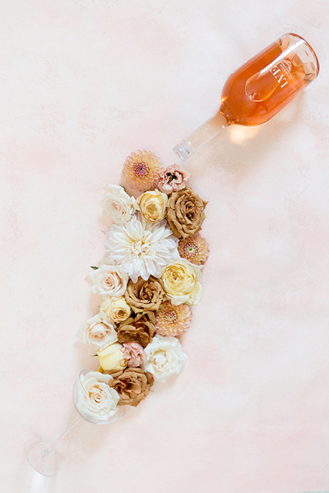  the bride in a white gown with an illusion neckline and hair in a low bun, the groom in a caramel brown suit with a chocolate brown bow tie 