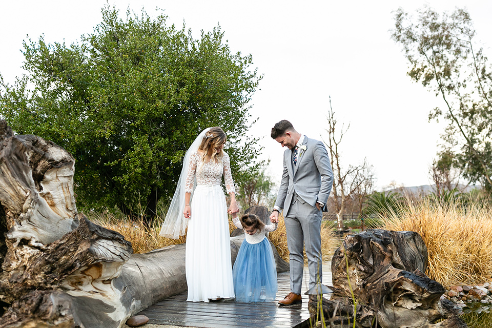  garden California floral wedding – couple walking with daughter 