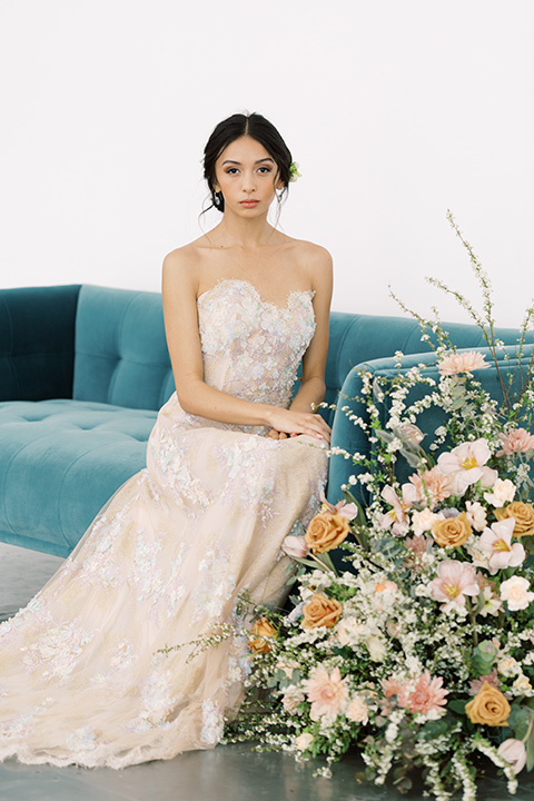  skyline dream with the bride in a formfitting lace gown and the groom in a tan suit 