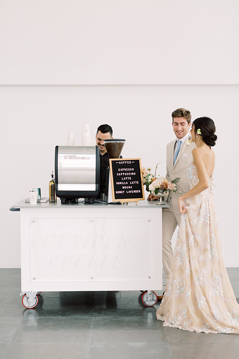  skyline dream with the bride in a formfitting lace gown and the groom in a tan suit 