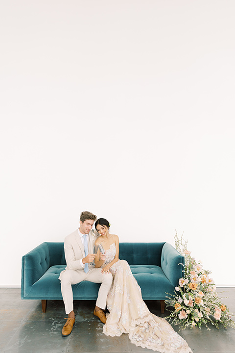  skyline dream with the bride in a formfitting lace gown and the groom in a tan suit 