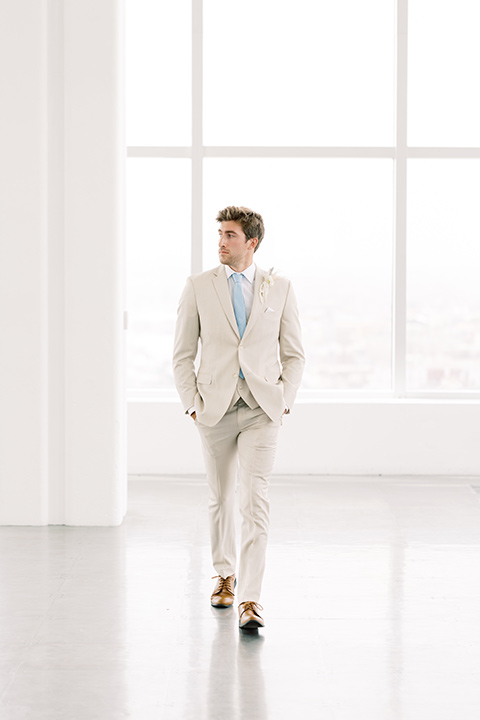  skyline dream with the bride in a formfitting lace gown and the groom in a tan suit