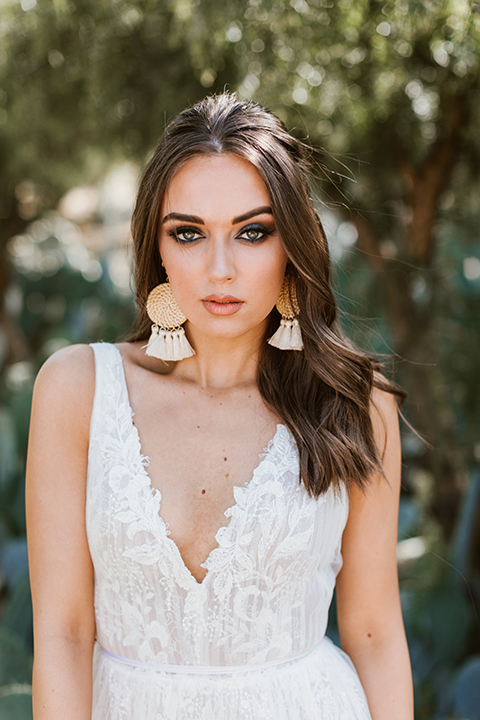 bride in a bohemian gown with chunky earrings 