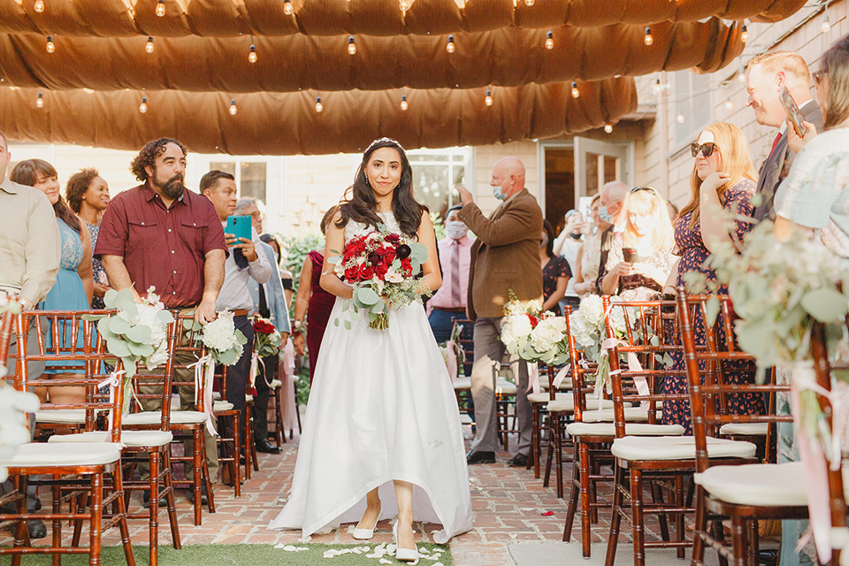  red and blue farmhouse wedding – bride walking down the aisle 