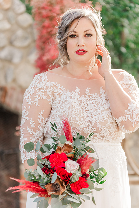  bride in a white and ivory gown with a natural waist and lace long sleeves 