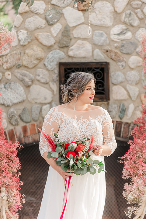  bride in a white and ivory gown with a natural waist and lace long sleeves 