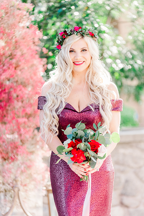  bridesmaid in a red velvet long gown and a floral headpiece
