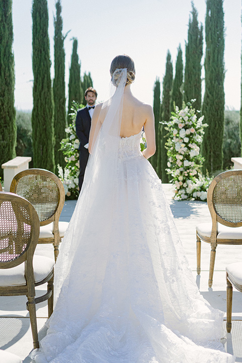  bride in a modern a line gown with a tulle skirt and the groom in a navy shawl lapel tuxedo