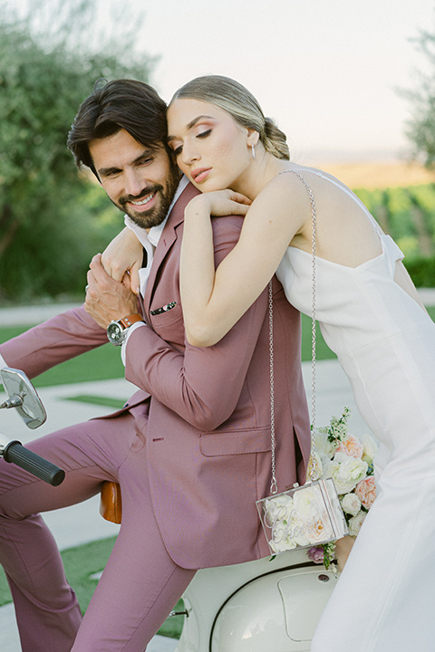  bride in a modern jumpsuit and the groom in a rose pink notch lapel tuxedo