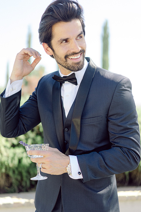  bride in a modern a line gown with a tulle skirt and the groom in a navy shawl lapel tuxedo