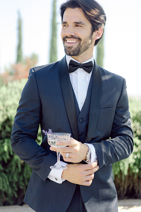  bride in a modern a line gown with a tulle skirt and the groom in a navy shawl lapel tuxedo 