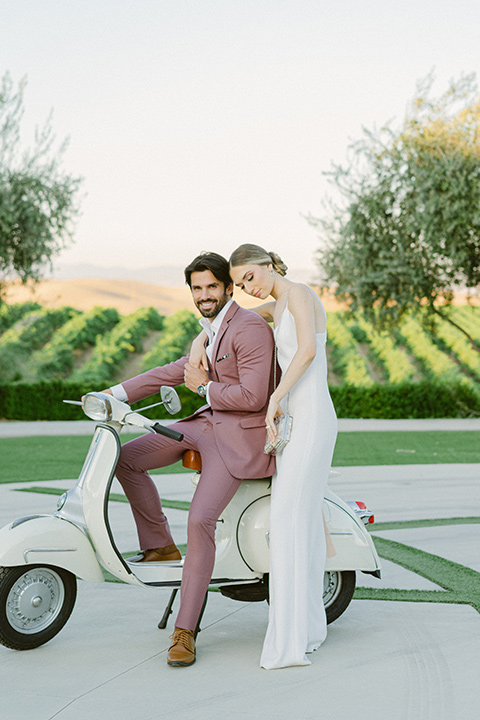  bride in a modern a line gown with a tulle skirt and the groom in a navy shawl lapel tuxedo 