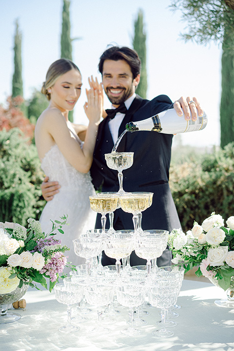  bride in a modern a line gown with a tulle skirt and the groom in a navy shawl lapel tuxedo 