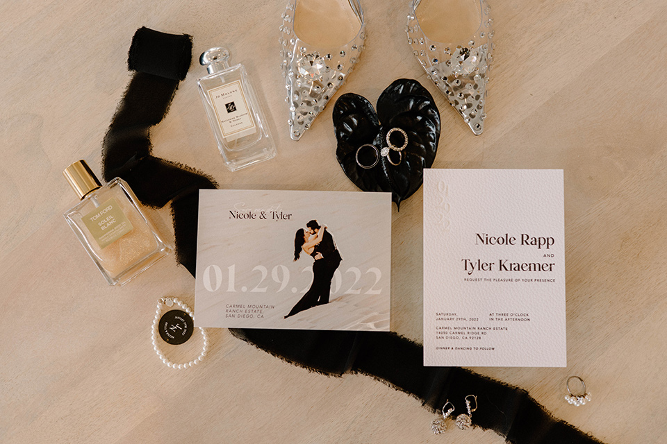  a chic black and white wedding with modern touches with the groom in a white tuxedo and the bride in a white ballgown and the bridesmaids and groomsmen in black dresses/tuxedos – invitations 