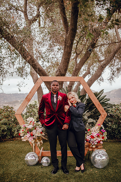  micro airbnb wedding with the bride and groom in suits – couple at ceremony arch 