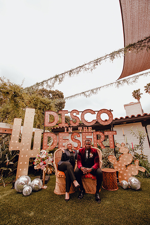  micro airbnb wedding with the bride and groom in suits – couple sitting 