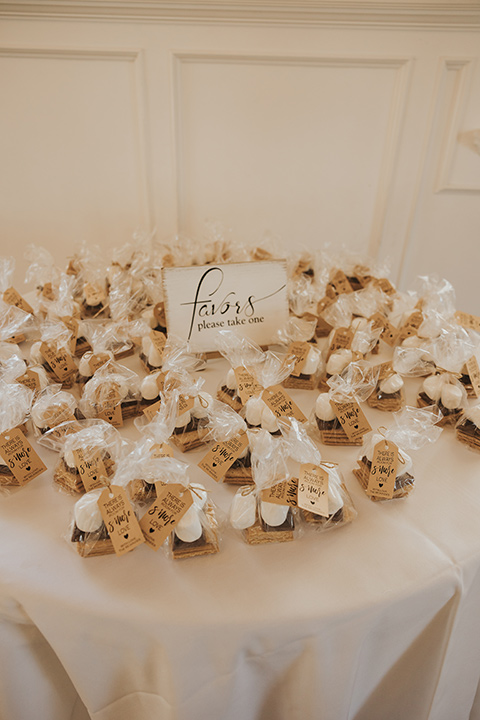  A dreamy amber toned wedding in Arizona at a wedgewood wedding venue – with the bride in a long sleeve lace gown and the bridesmaids in burnt orange dresses and the groom in a café brown suit and the groomsmen in a tan suit – wedding favors