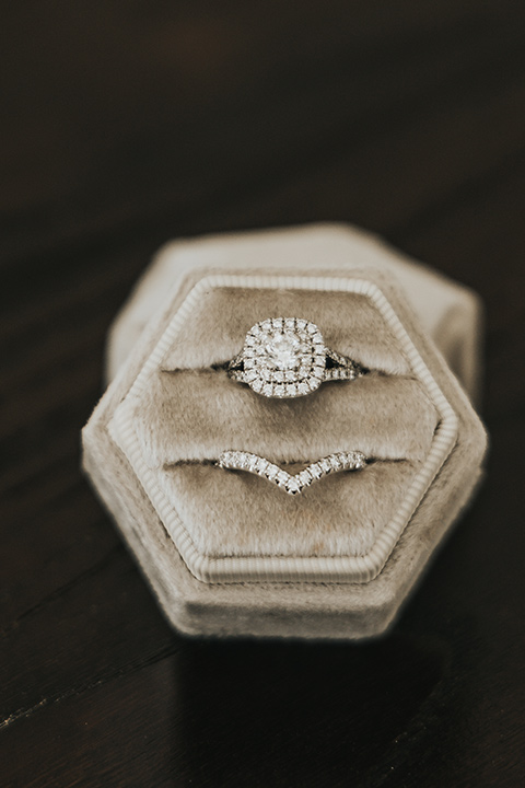  A dreamy amber toned wedding in Arizona at a wedgewood wedding venue – with the bride in a long sleeve lace gown and the bridesmaids in burnt orange dresses and the groom in a café brown suit and the groomsmen in a tan suit – brides ring 