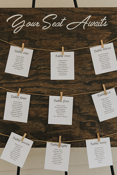  A dreamy amber toned wedding in Arizona at a wedgewood wedding venue – with the bride in a long sleeve lace gown and the bridesmaids in burnt orange dresses and the groom in a café brown suit and the groomsmen in a tan suit – seating chart