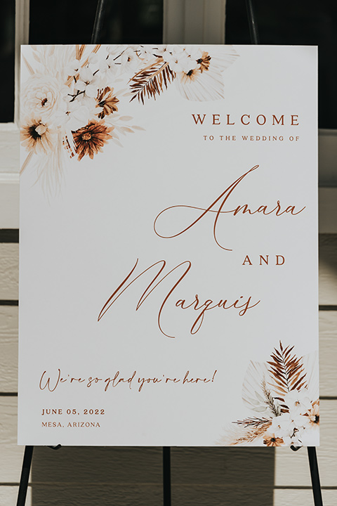  A dreamy amber toned wedding in Arizona at a wedgewood wedding venue – with the bride in a long sleeve lace gown and the bridesmaids in burnt orange dresses and the groom in a café brown suit and the groomsmen in a tan suit – welcome sign 