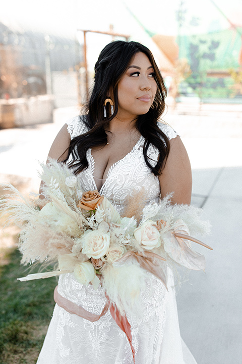  music inspired retro wedding with the bride in a lace gown and the groom in a green suit 