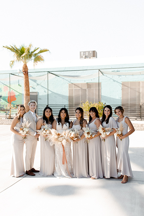  music inspired retro wedding with the bride in a lace gown and the groom in a green suit 